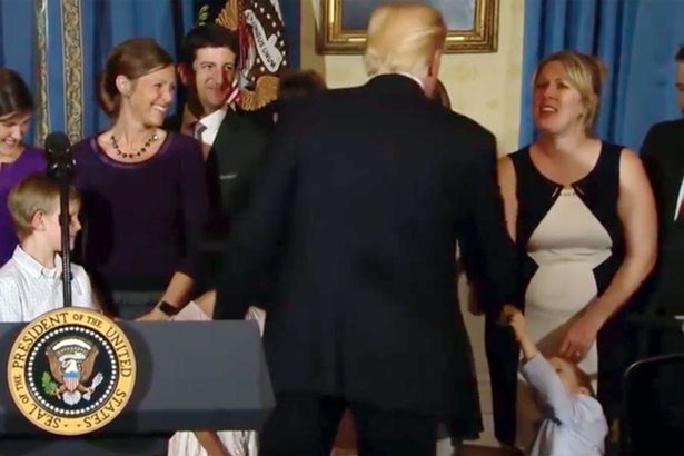 Donald Trump caught on camera appearing to refuse to shake disabled child's hand